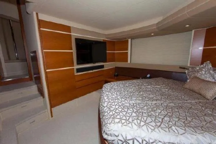 53 Flybridge Yacht Photos Pics Luxurious bedroom interior of 2012 Azimut 53 Flybridge yacht with modern decor and TV.