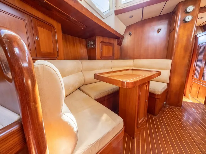 Tutkum Yacht Photos Pics Luxurious 2007 Tayana 48 yacht interior with wooden finish and cozy seating area.