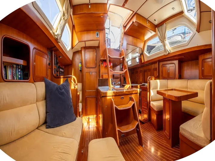 Tutkum Yacht Photos Pics Luxurious 2007 Tayana 48 yacht interior with wooden finish and comfortable seating.