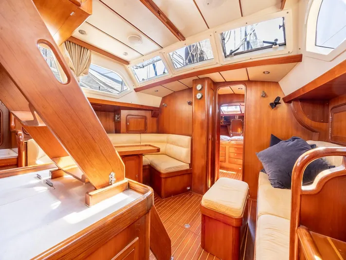 Tutkum Yacht Photos Pics Luxurious 2007 Tayana 48 yacht interior with wooden finish and comfortable seating.