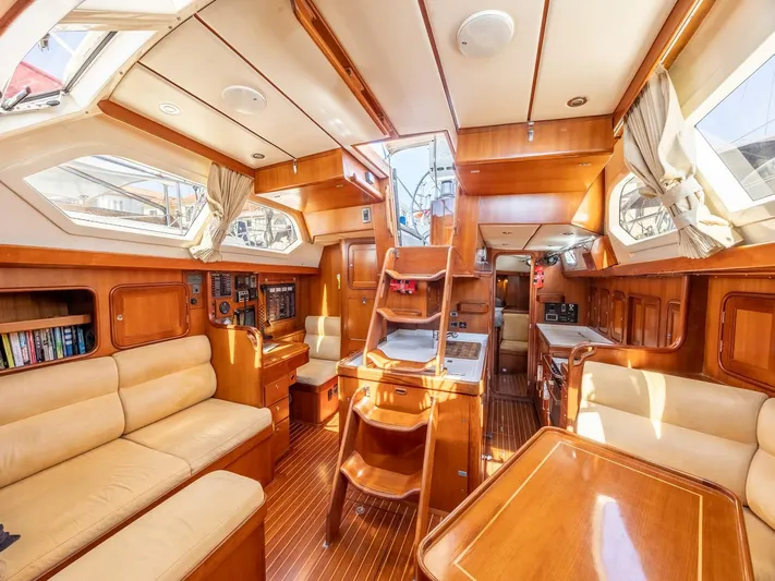 Tutkum Yacht Photos Pics Luxurious 2007 Tayana 48 yacht interior with wood finish and comfortable seating.