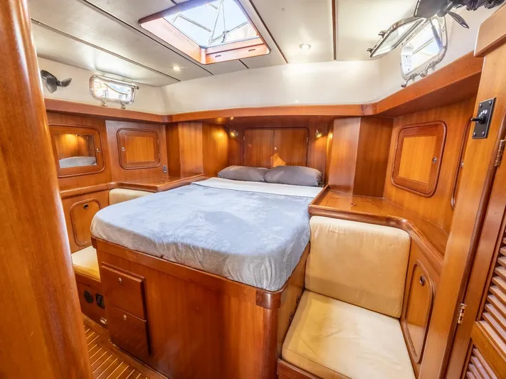 Tutkum Yacht Photos Pics Luxurious 2007 Tayana 48 yacht cabin with wood paneling and cozy bed.