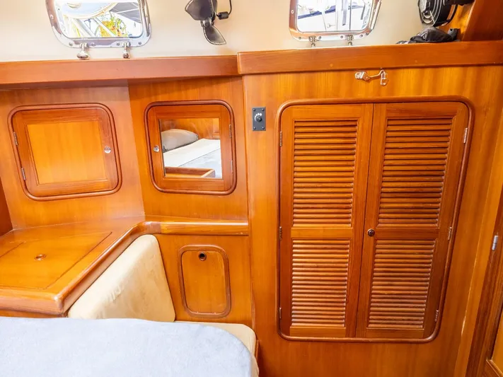 Tutkum Yacht Photos Pics Interior of 2007 Tayana 48 yacht with wooden cabinetry and cozy seating area.
