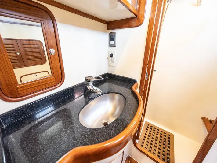 Tutkum Yacht Photos Pics Tayana 48 yacht bathroom with sleek sink, wooden accents, and mirror, 2007 model.