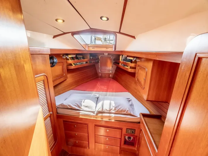 Tutkum Yacht Photos Pics Luxurious 2007 Tayana 48 yacht interior with wood finish and cozy sleeping area.