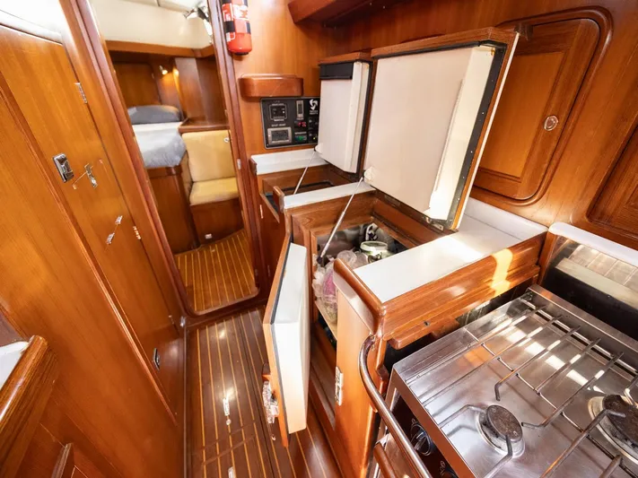 Tutkum Yacht Photos Pics Interior of 2007 Tayana 48 yacht with wood finish, kitchen, and sleeping area.