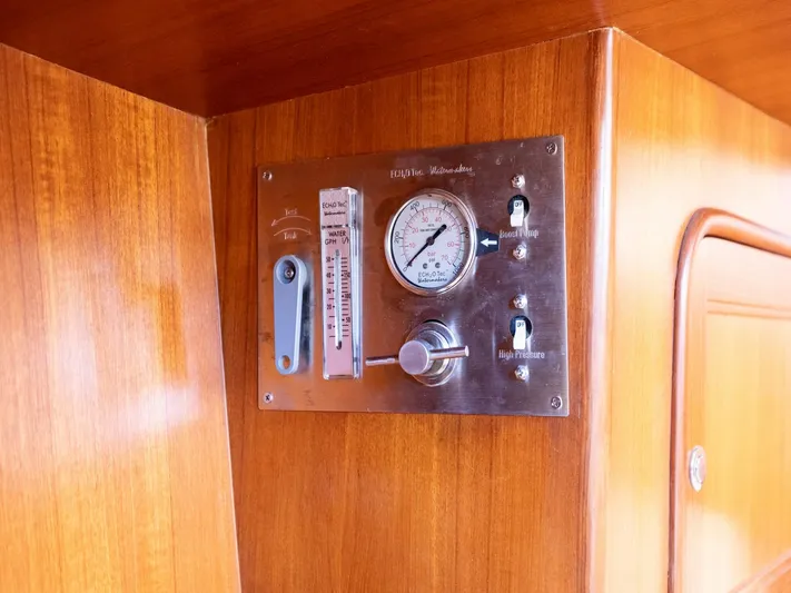 Tutkum Yacht Photos Pics Control panel on 2007 Tayana 48 yacht with gauges and switches on wooden surface.