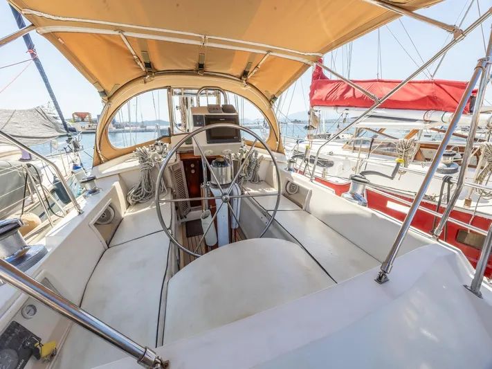 Tutkum Yacht Photos Pics Cockpit view of 2007 Tayana 48 sailboat with steering wheel and canopy.