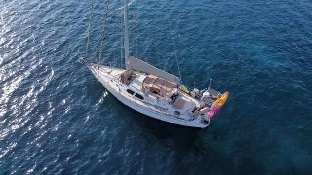 Tutkum Yacht Photos Pics Tayana 48 sailboat from 2007 on clear blue water, aerial view.