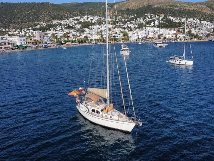 Tutkum Yacht Photos Pics Sailboat Tayana 48 (2007) anchored in a scenic coastal harbor.