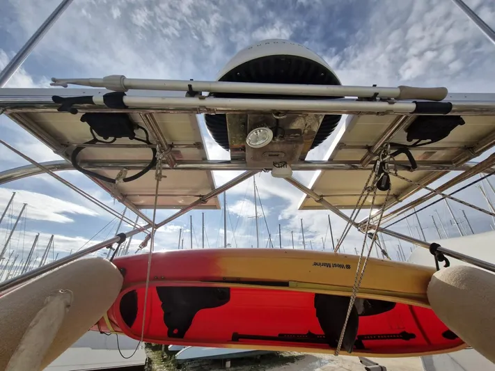 Tutkum Yacht Photos Pics Solar panels and kayak on a 2007 Tayana 48 sailboat under a blue sky.