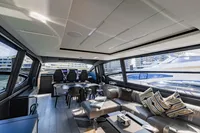 Luxurious interior of 2021 Pershing 8X yacht with modern seating and large windows.