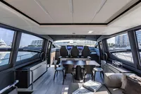 Luxurious interior of 2021 Pershing 8X yacht with modern seating and panoramic windows.