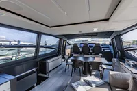 Luxurious interior of 2021 Pershing 8X yacht with modern seating and panoramic windows.
