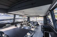 Luxurious interior of 2021 Pershing 8X yacht with modern furnishings and panoramic windows.