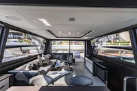 Luxurious interior of 2021 Pershing 8X yacht with modern seating and panoramic windows.
