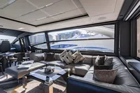 Luxurious interior of 2021 Pershing 8X yacht with modern seating and large windows.