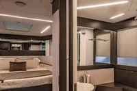 Luxurious interior of 2021 Pershing 8X yacht featuring bedroom and bathroom.