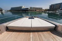 Luxury Pershing 8X yacht deck with sunbed, docked in a modern marina, 2021 model.