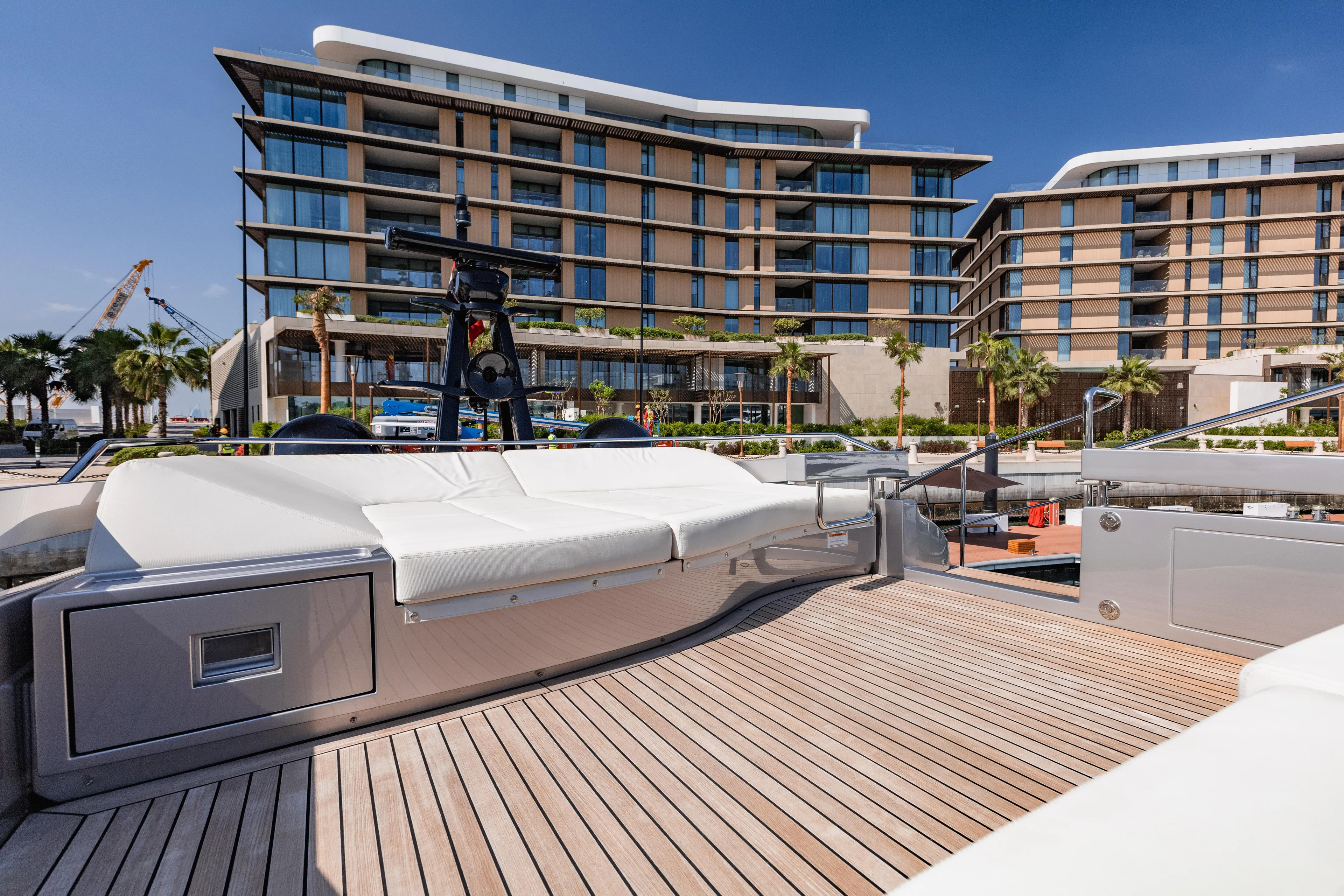 Luxury Pershing 8X yacht deck with modern building backdrop, 2021 model.