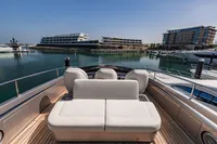 Luxury Pershing 8X yacht deck with seating, 2021 model, docked in a modern marina.