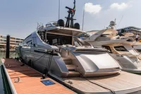 Luxury Pershing 8X yacht docked at marina, 2021 model, sleek design, sunny day.