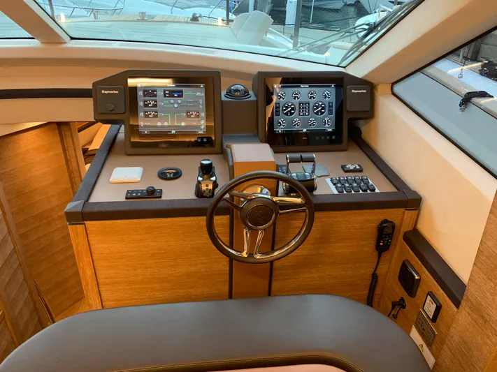 Remedy Yacht Photos Pics 2018 Monte Carlo Yachts MCY 65 helm station with advanced navigation systems.
