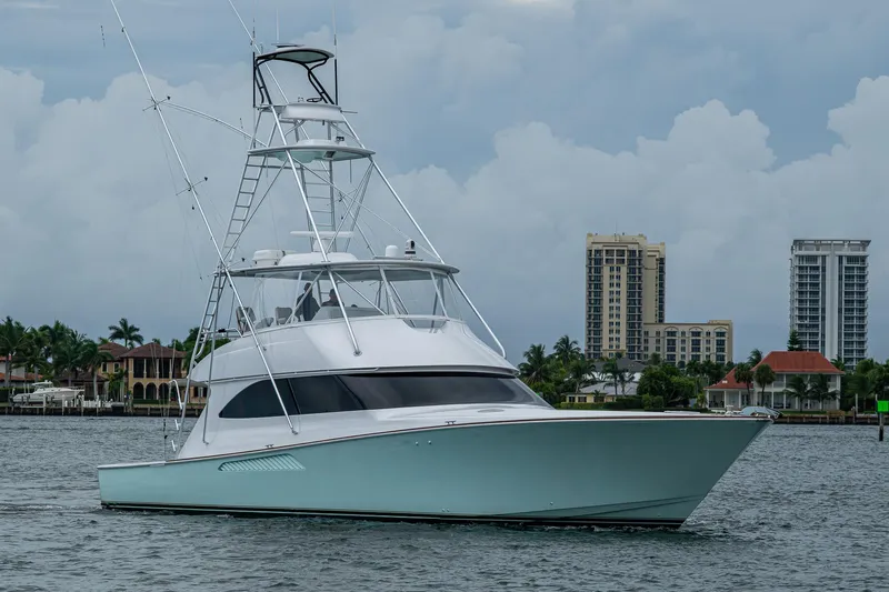 Ebitda Yacht Photos Pics 2009 Viking 60 Convertible yacht on water with cityscape background.