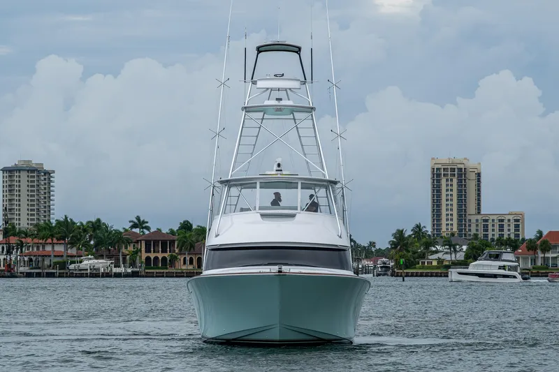 Ebitda Yacht Photos Pics 2009 Viking 60 Convertible yacht cruising in a scenic waterfront cityscape.