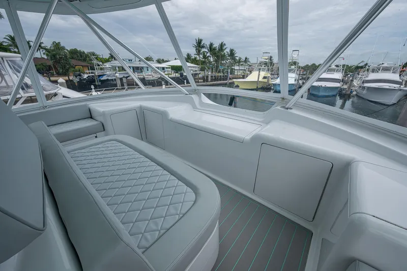 Ebitda Yacht Photos Pics 2009 Viking 60 Convertible yacht interior with cushioned seating and marina view.