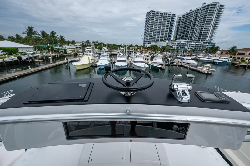 Ebitda Yacht Photos Pics Helm of 2009 Viking 60 Convertible yacht overlooking marina with boats and buildings.
