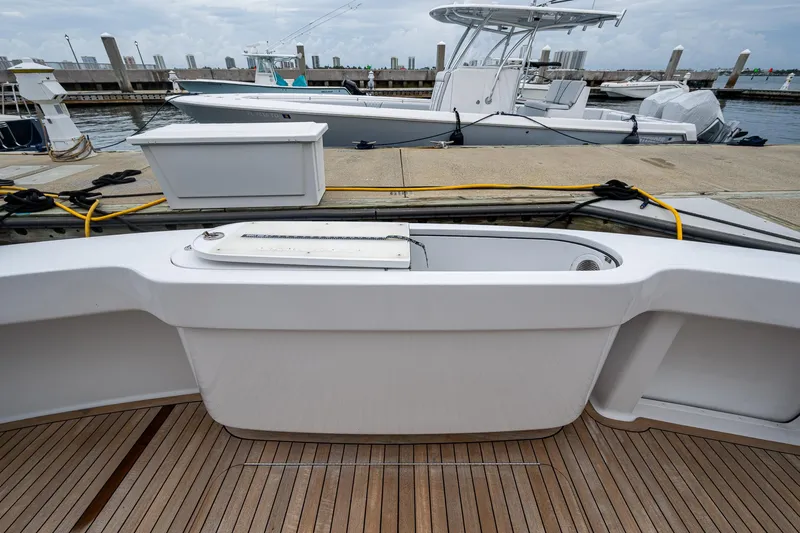 Ebitda Yacht Photos Pics 2009 Viking 60 Convertible yacht at dock with wooden deck and fishing equipment.