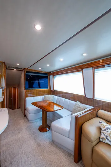 Ebitda Yacht Photos Pics Luxurious interior of 2009 Viking 60 Convertible yacht with plush seating and wooden accents.