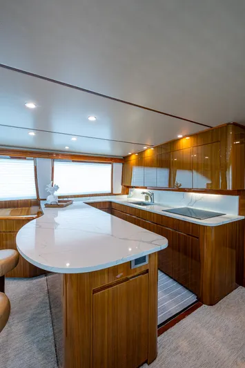 Ebitda Yacht Photos Pics Luxurious kitchen interior of 2009 Viking 60 Convertible yacht with modern design and wood finishes.