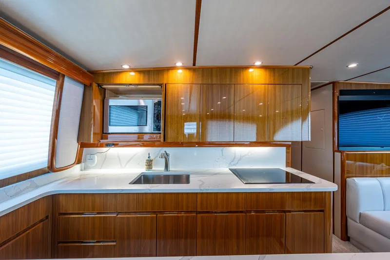Ebitda Yacht Photos Pics Luxurious kitchen interior of 2009 Viking 60 Convertible yacht with modern appliances.