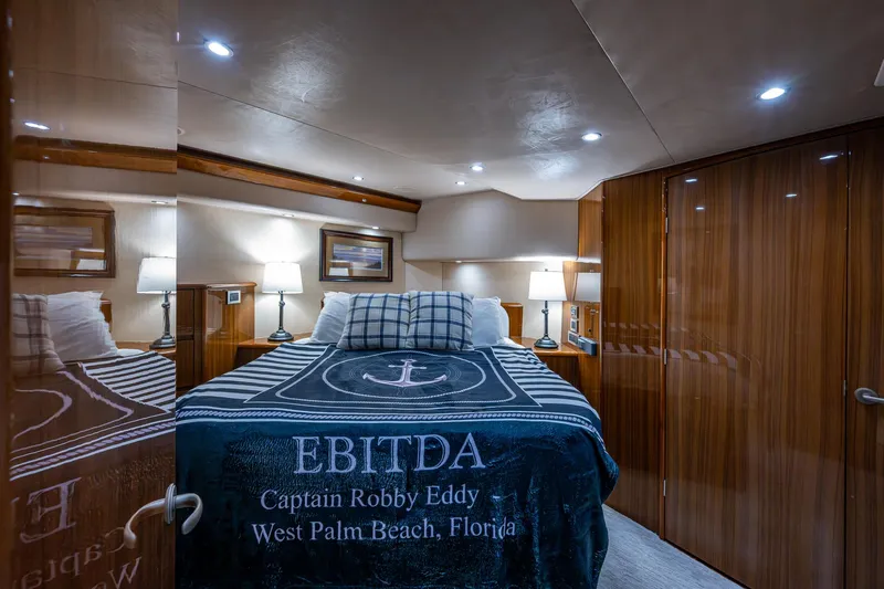 Ebitda Yacht Photos Pics Luxurious bedroom interior of 2009 Viking 60 Convertible yacht with elegant wood finishes.