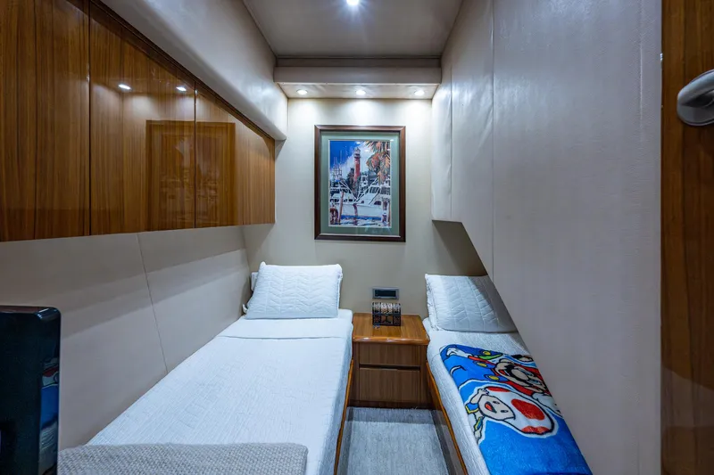 Ebitda Yacht Photos Pics Luxurious 2009 Viking 60 Convertible yacht cabin with twin beds and elegant wood finishes.