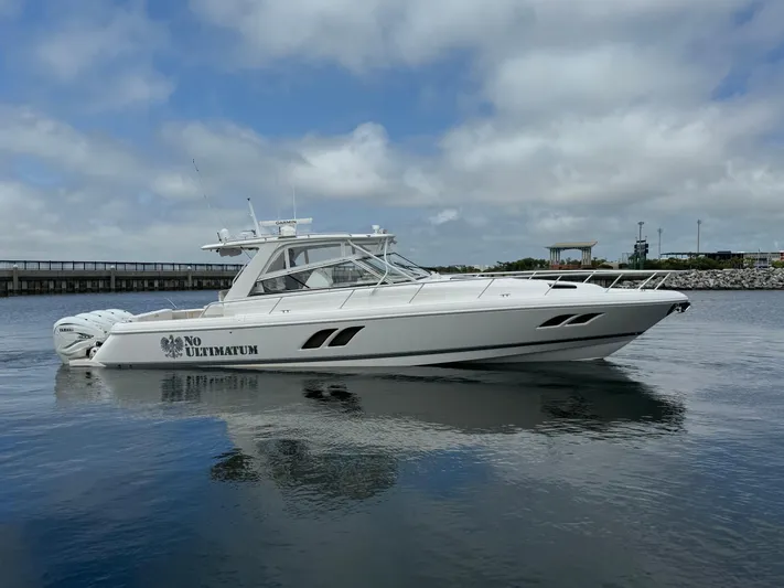  Yacht Photos Pics 2020 Intrepid 475 Sport Yacht on calm water under cloudy sky.