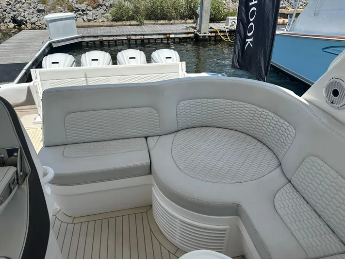  Yacht Photos Pics Luxurious seating on 2020 Intrepid 475 Sport Yacht, docked with outboard engines visible.