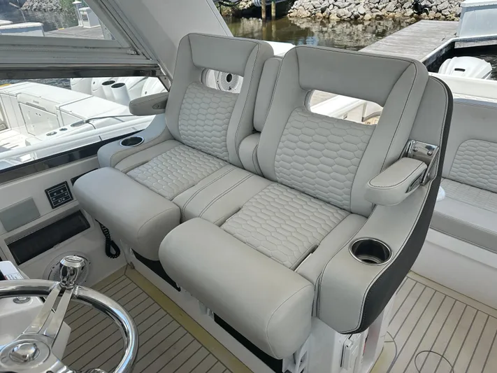  Yacht Photos Pics Luxurious seating on 2020 Intrepid 475 Sport Yacht, featuring plush upholstery and cup holders.