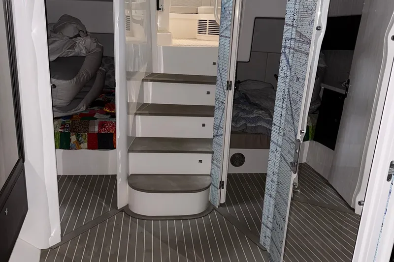  Yacht Photos Pics Interior of 2020 Intrepid 475 Sport Yacht, featuring stairs and cozy sleeping quarters.