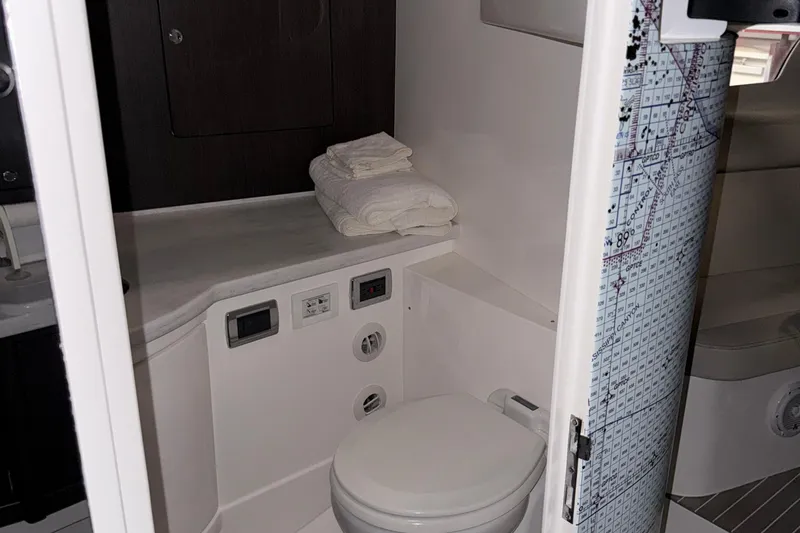  Yacht Photos Pics 2020 Intrepid 475 Sport Yacht bathroom with modern fixtures and folded towels.
