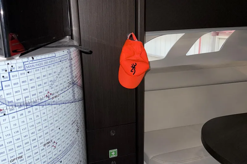  Yacht Photos Pics Interior of 2020 Intrepid 475 Sport Yacht with orange cap and nautical chart.