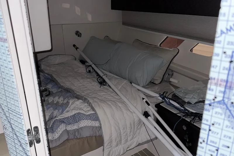 Yacht Photos Pics Cozy cabin interior of 2020 Intrepid 475 Sport Yacht with bed and nautical equipment.