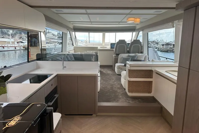  Yacht Photos Pics Luxurious interior of 2024 Azimut Magellano 60 yacht with modern kitchen and seating area.