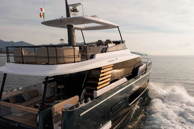  Yacht Photos Pics 2024 Azimut Magellano 60 yacht cruising on open water, showcasing luxury design and spacious deck.