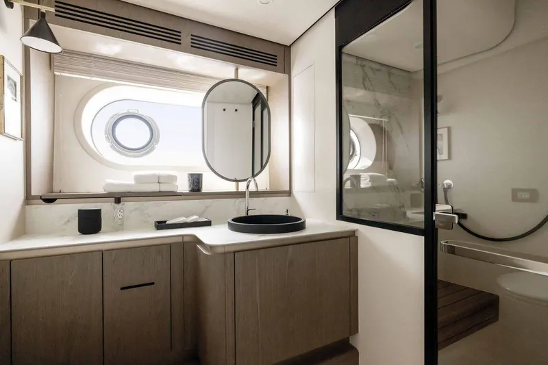  Yacht Photos Pics Luxurious bathroom in 2024 Azimut Magellano 60 yacht, featuring modern design and elegant fixtures.
