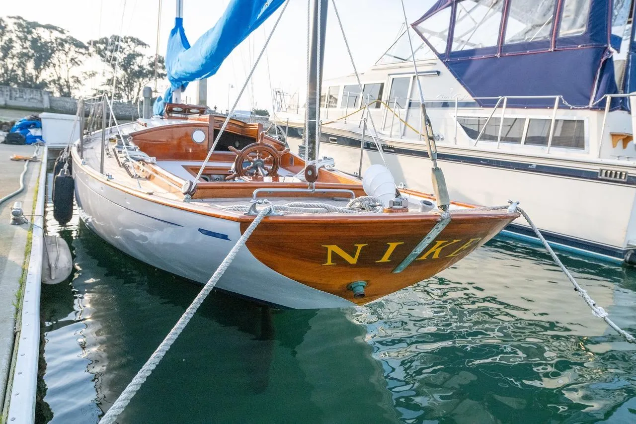 Vintage 1938 Philip Rhodes Cutter sailboat docked, showcasing elegant wooden design and classic craftsmanship.
