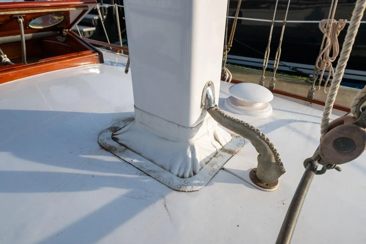 Close-up of 1938 Philip Rhodes Cutter sailboat deck with mast and rigging details.