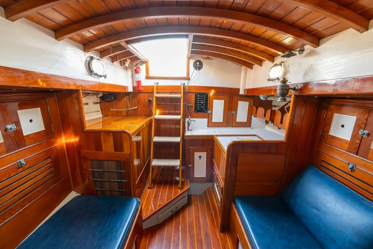 Interior of a 1938 Philip Rhodes Cutter, featuring polished wood and classic nautical design.